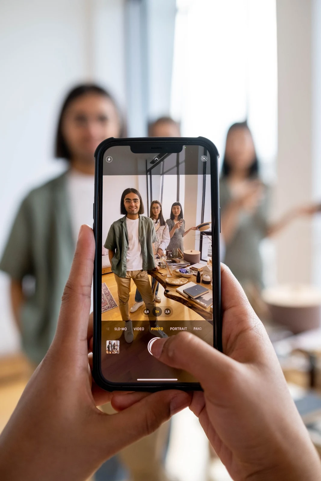 A phone camera framing friends together