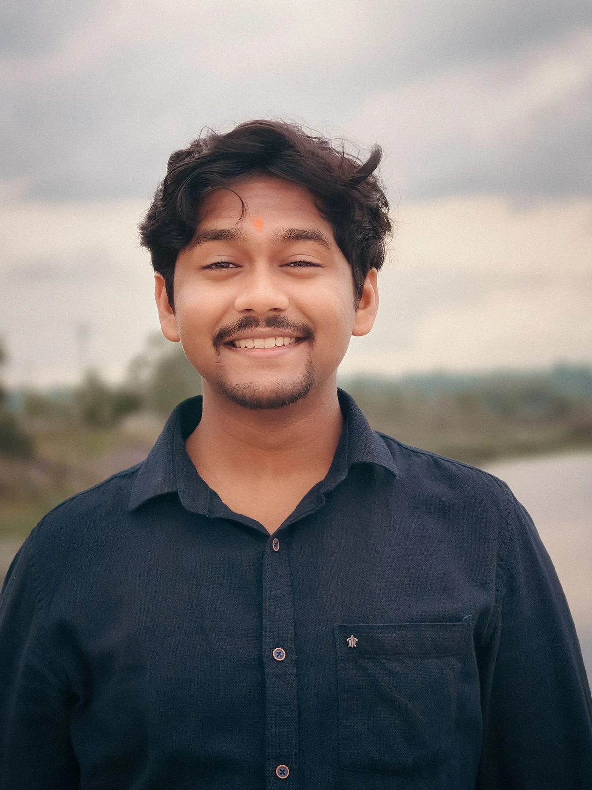 A smiling man photographed outdoors