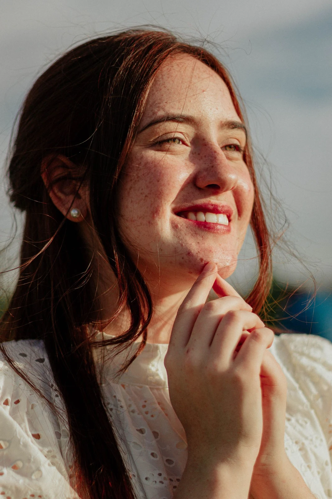 A smiling woman photographed in warm natural light