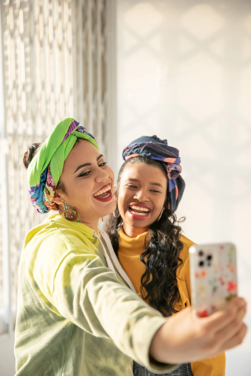 Two friends smiling for a selfie together